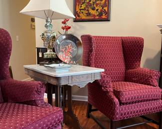 Wing chairs and marble top table. Capodimonte table lamp.