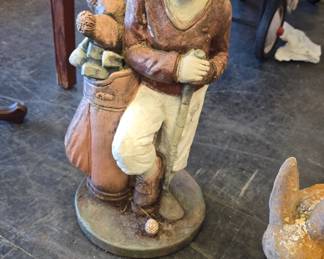 concrete statue with golf clubs 