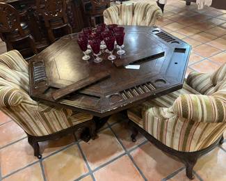 Solid rustic wood game table 65” H 30 1/4”
Club rollback, armchairs, striped tufted roller wheels.