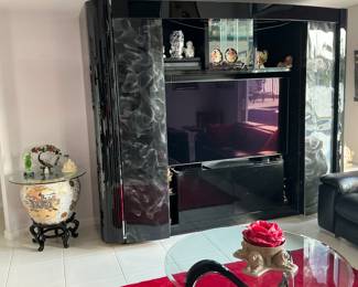 Wallunit with sliding doors to cover TV when closed it shows display shelves on either side.  It worked with a remote, but is no longer working that way.