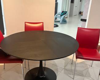 Black breakfast table with 4 Cattelian Italia red chairs