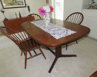 Made in Denmark, "Gudme Mobelfabrik", teak dining table with two leaves stored underneath.