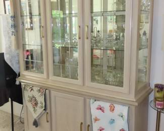 Blonde oak china hutch with mirrored back and  cabinets below.