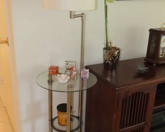 Three teired glass shelves with brush nickel lamp.