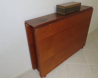 MCM when stowed away this Swedish teak dining table measures 8 inches deep but when extended it measures 9 ft long and 39 inches wide. It has 4 hinged leaves and legs that unfold revealing this great table.