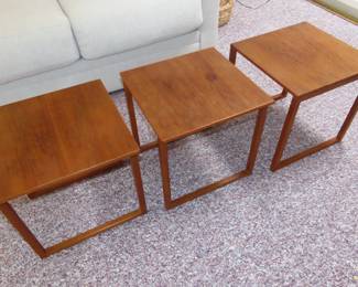 Three teak end tables that store as a cube. Made in Denmark.