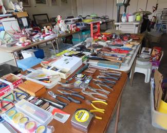 Tables of hand tools, Christmas decorations, plastics, light bulbs, potting bench/cabinet, flower pots.