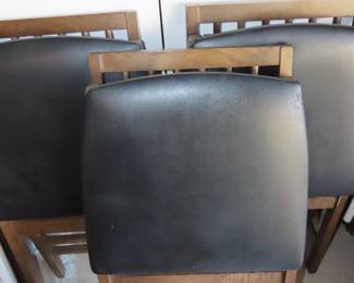 Three wooden folding chairs with vinyl seats.