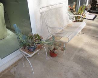 White metal and mesh glider loveseat, end tables and plants.