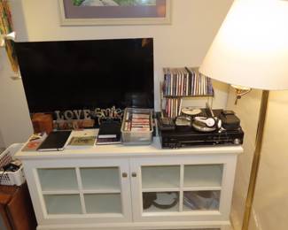 TV stand/media storage, DVD/VHS combo, TV, love signs, DVDs, cassettes. wireless earphones, personal CD players.