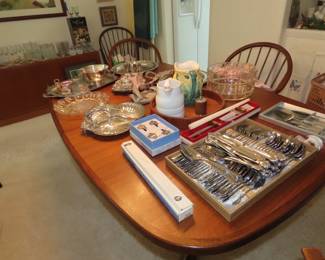 Dining table with teak and silver plate items