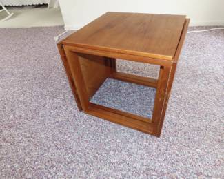 Three teak end tables that store as a cube. Made in Denmark.