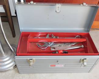 Heavy duty metal tool chest filled with hand tools.
