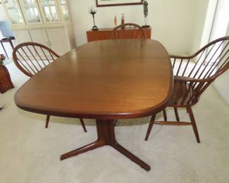 Made in Denmark, "Gudme Mobelfabrik", teak dining table with two leaves stored underneath.