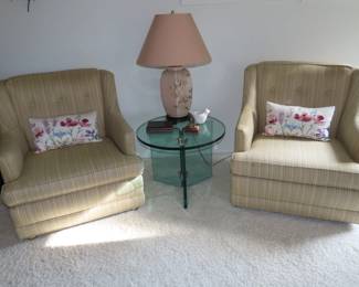Two matching armchairs, glass end table.