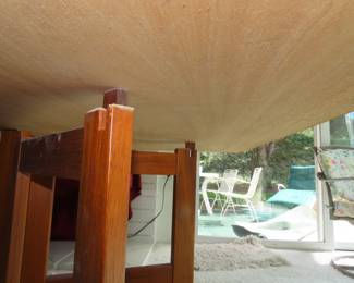 MCM when stowed away this Swedish teak dining table measures 8 inches deep but when extended it measures 9 ft long and 39 inches wide. It has 4 hinged leaves and legs that unfold revealing this great table.