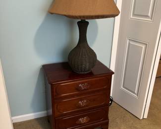 Antique nightstand with vintage wicker lamp
