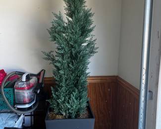 Two faux evergreens in pots
