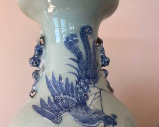 a Chinese blue/white porcelain vase with a celadon ground, likely from the 19th century. 
It features underglaze blue hand-painted decorations on a pale green celadon body. motifs phoenix and peonies, 23”h x 9.5” diameter aprox 20lbs
