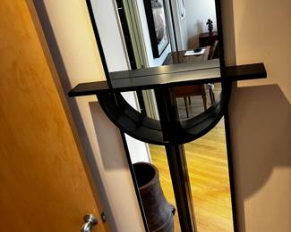 Wall Mirror with Sculptural Black  Shelf in a style of cross
66”h x 27”w x 5.5” deep overall dimensions
Shelf 27”w x 3.5” d 
$800

