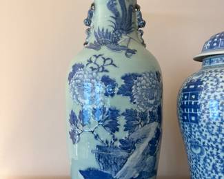a Chinese blue/white porcelain vase with a celadon ground, likely from the 19th century. 
It features underglaze blue hand-painted decorations on a pale green celadon body. motifs phoenix and peonies, 23”h x 9.5” diameter aprox 20lbs