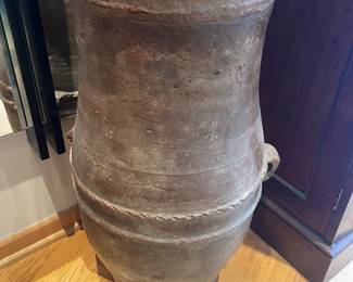 Large antique floor vase or urn, potentially of the Tsuboya ware style from the Ryukyu Kingdom (now Okinawa, Japan). The vase features a rustic, earthy tone and a textured surface, with rope-like detailing around the middle and two small rounded handles.
29”h x 16” overall diameter and 12” diameter opening 
Aprox 50 lbs
$1800