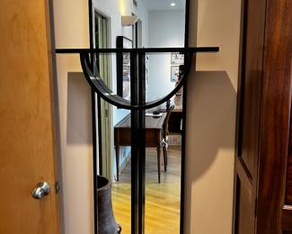 Wall Mirror with Sculptural Black  Shelf in a style of cross
66”h x 27”w x 5.5” deep overall dimensions 
$800

