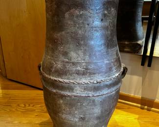 Large antique floor vase or urn, potentially of the Tsuboya ware style from the Ryukyu Kingdom (now Okinawa, Japan). The vase features a rustic, earthy tone and a textured surface, with rope-like detailing around the middle and two small rounded handles.
29”h x 16” overall diameter and 12” diameter opening 
Aprox 50 lbs
$1800