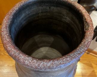 Large antique floor vase or urn, potentially of the Tsuboya ware style from the Ryukyu Kingdom (now Okinawa, Japan). The vase features a rustic, earthy tone and a textured surface, with rope-like detailing around the middle and two small rounded handles.
29”h x 16” overall diameter and 12” diameter opening 
Aprox 50 lbs
$1800