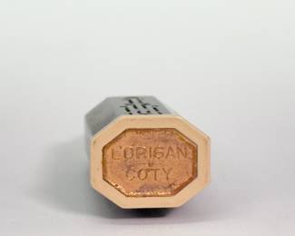 Closeup of French Art Deco perfume bottles - a pair of 'Duska' red glass perfume bottle with a black glass stopper, pyramidal in shape with steps resembling a stylized skyscraper probably made by Cristalleries de Nancy, 1928; a Coty Styx Perfume pierced brass Art Deco wrapped perfume bottle, and a 1920's Renaud France jadeite green glass perfume bottle