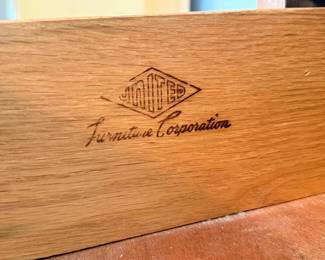 Closeup of brand markings on mid-century nightstand and highboy dresser by United Furniture Corporation