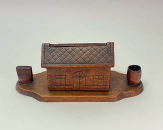 Another view of 1922 hand carved American Folk Art mechanical cigarette dispenser with a match box holder and a cup for spent matches, made by Chaim Chandowsky while a prisoner of war in Białystok, Poland