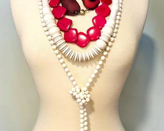 Costume jewelry necklaces including ropes of small white beads, chunky large beads and discs, and sliced stones