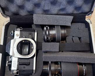 Canon AE-1 camera and two lenses in fitted hardshell carrying case