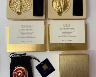 Estée Lauder Aquarius compact in original packaging, Estée Lauder Gemini compact in original packaging, Estee Lauder "Red Swirls" Powder Compact in original packaging and pouch