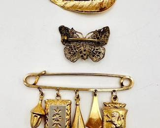 Reverse view of vintage costume jewelry brooches
