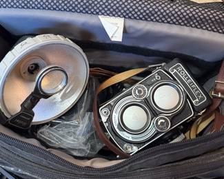 Closeup of Rolleiflex camera and flash attachment, padded carrying case