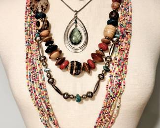Variety of costume jewelry necklaces, large and small beads - metal, glass, wood, one with large pendant