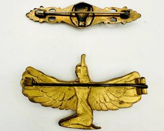 Reverse view of vintage Egyptian Revival style brooches and pins