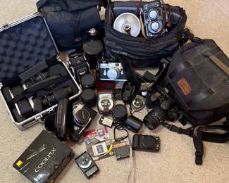 Camera collection - Rolleiflex, Canon, Minolta, Leica, Coolpix, Sony, and more. Lenses, carrying cases, lens filters, light meters, memory cards galore! Lots more photos to see.