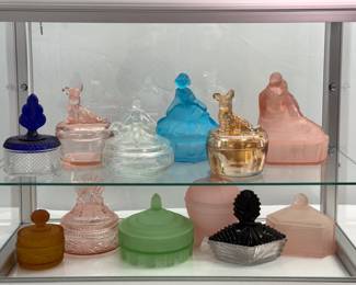 Beautiful vintage Art Deco collectible glass trinket and powder boxes including a Martinsville Geneva Brilliant Diamond Pattern Clear Glass Powder Base & Blue Lid, two Jeannette Glass Company Scottish Terrier Dog Trinket Dish Powder Jars, a Hocking Glass Co. Aqua Blue Satin Dancing Girl powder box, an L. E. Smith Lovers powder jar, an Art Deco circa 1920/1930’s green glass  “Neckar” powder and trinket bowl, a Martinsville Black & Clear Glass Art Deco Dresser Box, and more