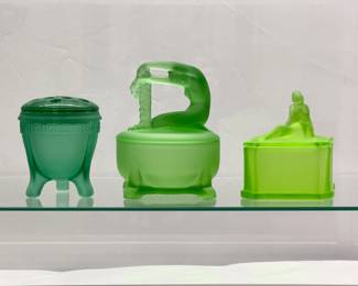 A vintage LE Smith uranium glass Greek key footed flower frog or Flowerlite vase, a Dermay Inc satin finish uranium glass Rapunzel powder jar, and a circa 1929 Phoenix Glass Co. frosted finish uranium glass powder jar