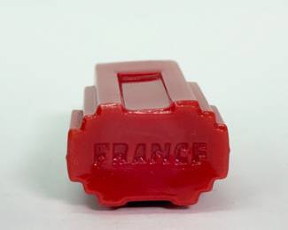 Closeup of French Art Deco perfume bottles - a pair of 'Duska' red glass perfume bottle with a black glass stopper, pyramidal in shape with steps resembling a stylized skyscraper probably made by Cristalleries de Nancy, 1928; a Coty Styx Perfume pierced brass Art Deco wrapped perfume bottle, and a 1920's Renaud France jadeite green glass perfume bottle