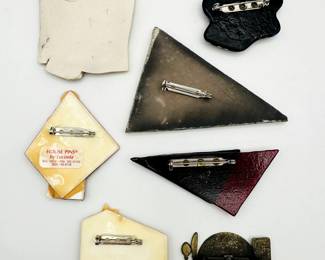 Reverse view of the costume jewelry pins and brooches of many styles