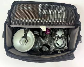 Soft shell padded carrying case with the Rolleiflex camera and its accessories and attachments 