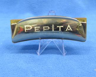 Lot 197. Koestler curved diatonic Pepita tremolo harmonica. Made in the "U.S. Zone Germany" Some holes lack sound. Box in excellent condition.