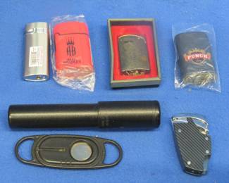 Lot 145. Collectible lighters: Punch; Alec Bradley; Grey and silver tone; Silvertone lighter; and more
