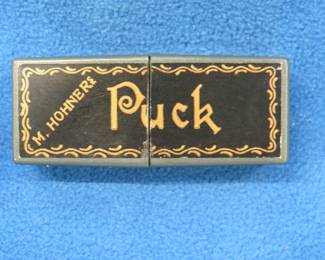 Lot 114. Hohner 2 1/2" Puck diatonic harmonica in the key of C. Sound and plastic box are in excellent condition.