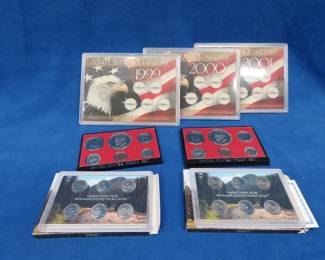 Lot 413. Three empty state series Quarter sets: 1999, 2000, 2001. Two Westward Journey 6-nickel sets. Two 1975 Proof sets.