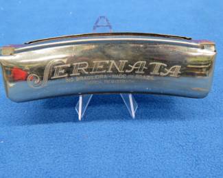 Lot 277. Serenata 14-hole tremolo curved harmonica made in Brazil. Sounds great and box in good condition